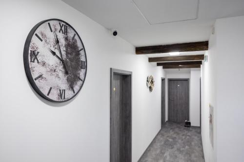 a clock on the wall of a hallway at Penzion Rozhovice in Rozhovice