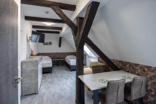 a room with a dining table and a living room at Penzion Rozhovice in Rozhovice