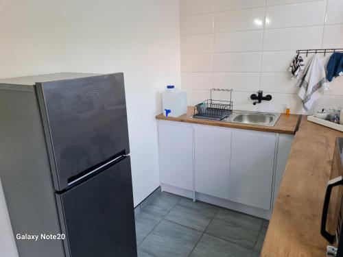 a kitchen with a sink and a refrigerator at Egerton Overnight & Stay in Kimberley