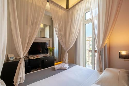 a bedroom with a bed and a large window at At Home Townhouse - Filiberto in Rome