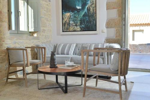 a living room with a couch and two chairs and a table at Akrolithi Boutique Hotel & Suites in Oítilon