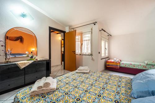 a bedroom with two beds and a sink and a mirror at Casa Flu in Assemini