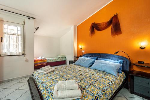 um quarto com uma cama com uma parede laranja em Casa Flu em Assemini