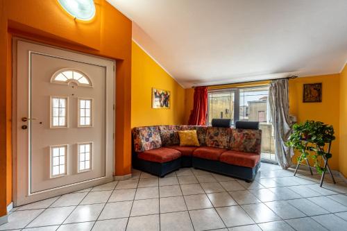 a living room with a couch next to a door at Casa Flu in Assemini