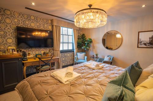 a bedroom with a bed and a sink and a mirror at Salisbury Arms Hotel in Hertford