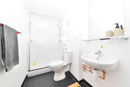 a white bathroom with a toilet and a sink at For Students Only Ensuite Bedroom at Beton House in Sheffield in Sheffield