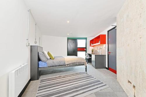 a bedroom with a bed in the middle of a room at For Students Only Ensuite Bedroom with Shared Kitchen at Beton House in Sheffield in Sheffield