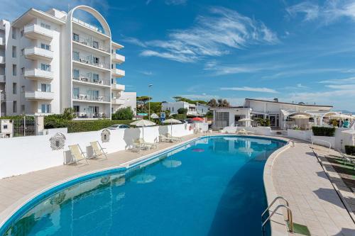 a large swimming pool next to a building at Residence Cavalluccio Marino in Santa Marinella