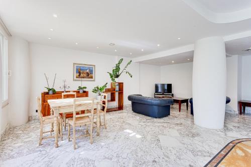 a living room with a table and a blue couch at Residence Cavalluccio Marino in Santa Marinella