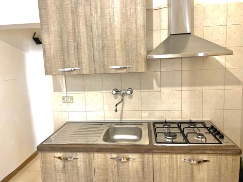 a kitchen with a sink and a stove at Appartamento Azzurra in Lecce