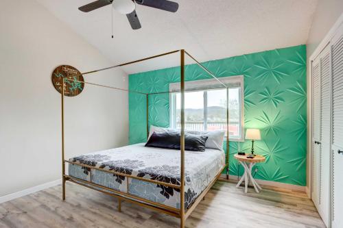 a bedroom with a canopy bed and a green wall at Lakefront Vacation Rental with Dock and Views! in Camdenton