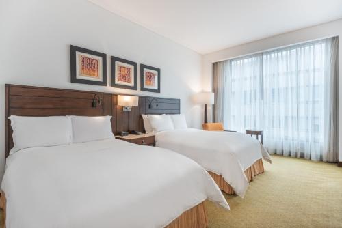 a hotel room with two beds and a window at Bogotá Marriott Hotel in Bogotá