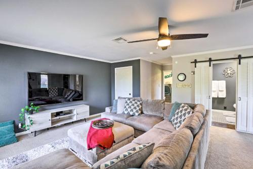 a living room with a couch and a flat screen tv at Sunny Florida Abode - Patio, Pool, and Fire Pit in Marianna