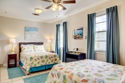 a bedroom with two beds and a ceiling fan at Coastal Long Beach Rental with Patio, Walk to Beach! in Long Beach