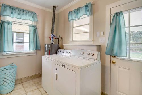 a washing machine in a laundry room with blue curtains at Coastal Long Beach Rental with Patio, Walk to Beach! in Long Beach