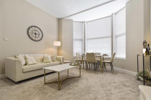 a living room with a couch and a table at The Park Road Suites by Central Beach Leisure in Blackpool