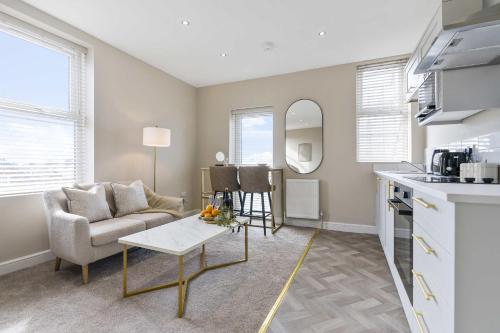 a living room with a couch and a table at The Park Road Suites by Central Beach Leisure in Blackpool