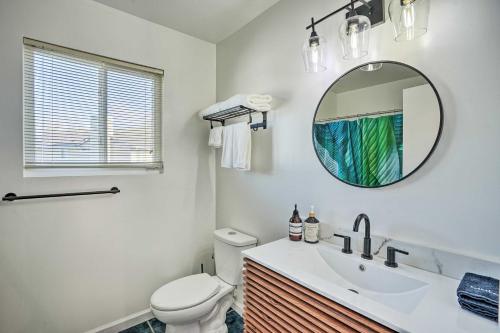 a bathroom with a toilet and a sink and a mirror at Bay Area Home Rental Near Six Flags and Napa Valley! in Vallejo