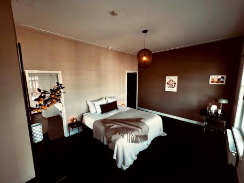 een slaapkamer met een bed en een spiegel bij Boutique Hotel het Oude Raadhuis in Castricum