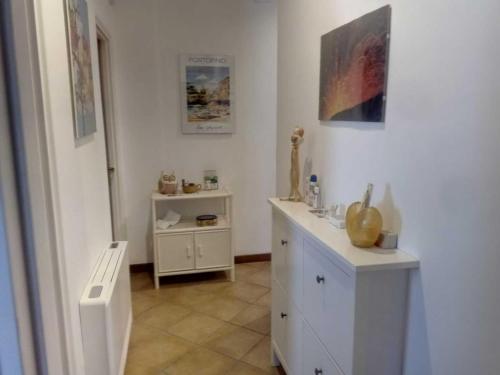 a white bathroom with a counter and a sink at Casale Boschetto Etna in Biancavilla