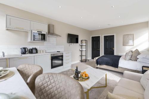 a kitchen and living room with a bed and a living room at The Park Road Suites by Central Beach Leisure in Blackpool