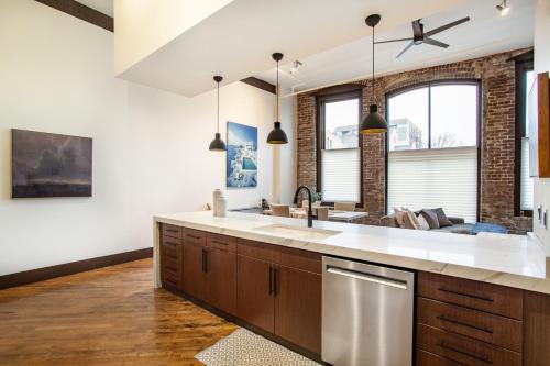 a kitchen with a sink and a dishwasher at Jackson Jewel - Downtown Suite in Knoxville