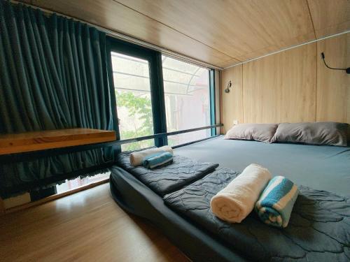 a bedroom with a large bed with towels on it at Laca Hostel in Ho Chi Minh City