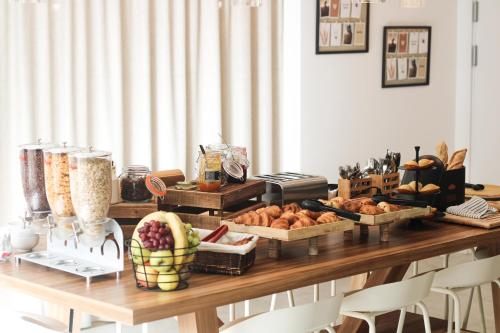 a table topped with lots of bread and other foods at Campanile Melun Sénart in Vert-Saint-Denis