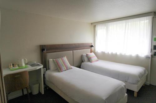 Ein Bett oder Betten in einem Zimmer der Unterkunft Campanile Melun Sénart