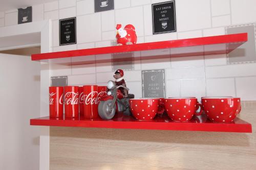 a store shelf with cocacola cups and a santa claus figurine at Skyline in Ypres