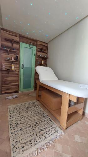 a room with a large bed and a rug at Riad Lalla Mimouna in Marrakech