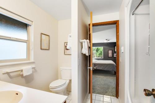 a bathroom with a toilet and a sink at The Treehouse in Bellingham