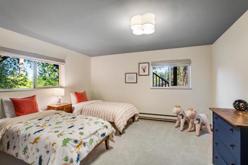 a bedroom with two beds and two windows at The Treehouse in Bellingham