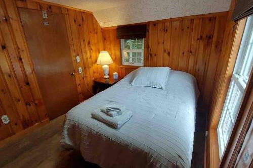 a bedroom with a bed with a towel on it at Riverside Cabin with Private Fishing Access! in Pulaski