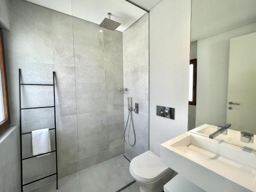 a bathroom with a shower and a toilet and a sink at Vila Ruby - Private Pool by HD PROPERTIES in Vilamoura