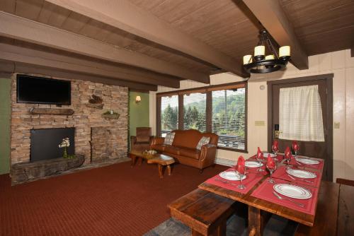 a living room with a table and a fireplace at Seven Springs Resort Properties in Champion