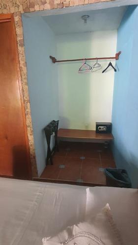 a bedroom with a bed and a bench in a room at Cabañas Colibrí in Bacalar
