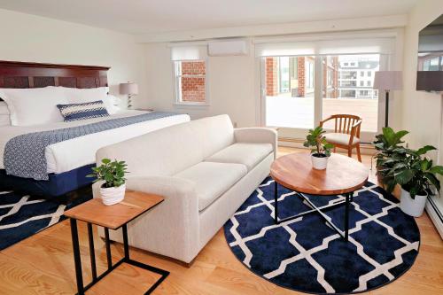 a living room with a couch and a bed at Harborside Inn in Newport
