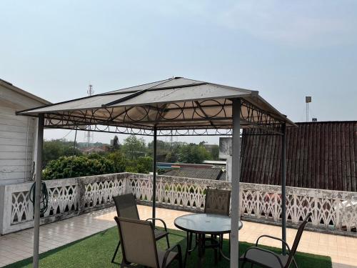 a gazebo with a table and chairs on a patio at Herritage Piman since 1940 in San Kamphaeng