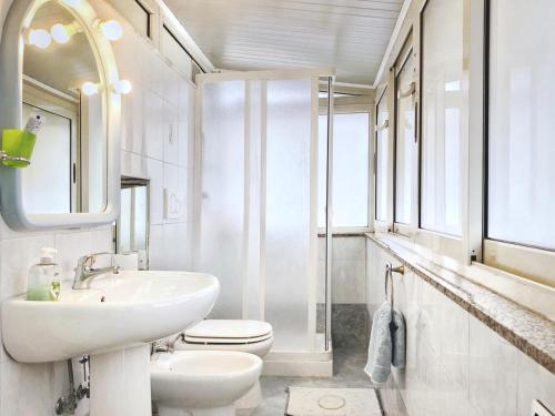 a white bathroom with a sink and a toilet at Tiziana in Giardini Naxos