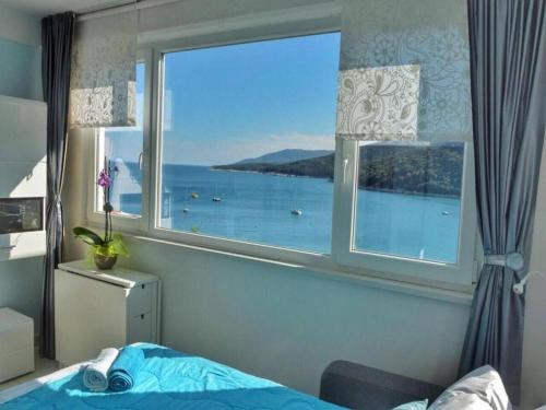 1 dormitorio con ventana y vistas al agua en Apartment By the Sea, en Rabac