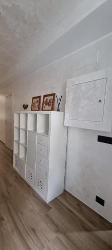 a white room with a shelf and a white wall at The Hemme's Home in Genova