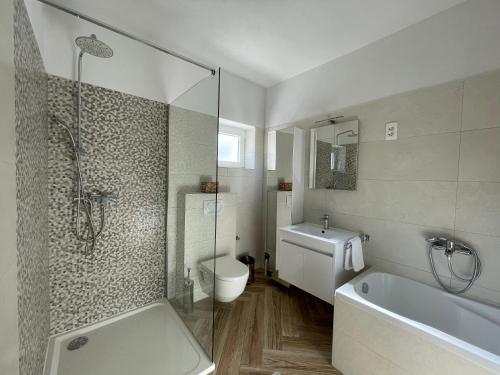 ein Badezimmer mit einer Badewanne, einem WC und einem Waschbecken in der Unterkunft Apartment Marina in Senj