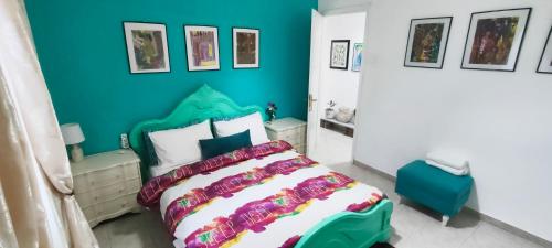a bedroom with a bed and a blue wall at Quiet House with Private Garden in Katerini