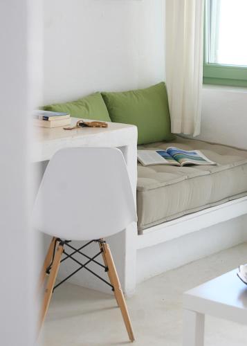a living room with a couch and a chair at Kallichoron Art Boutique Hotel in Astypalaia Town