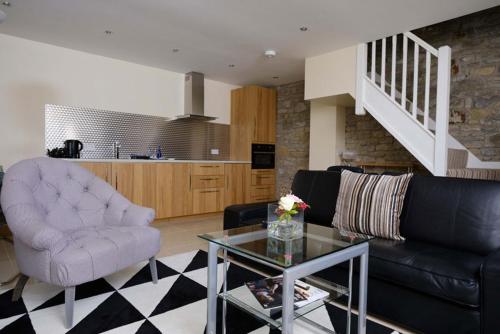 a living room with a couch and a table at The Great House Hotel in Bridgend