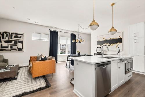 a kitchen with a sink and a living room at Mason Lofts at West End in Nashville