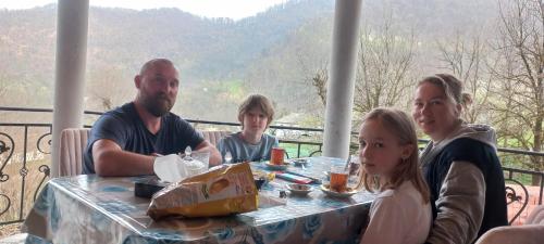 a group of people sitting at a table at Sim Guesthouse in Sım