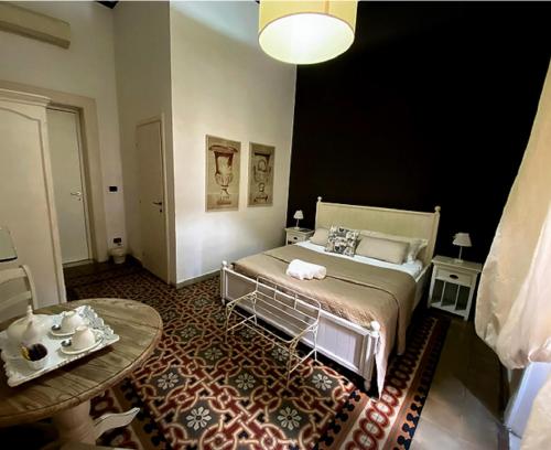 a bedroom with a bed and a table in it at Casa Blanca in Reggio Calabria
