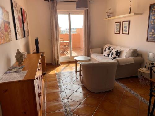 a living room with a couch and a table at Apartamentos Mar Azul in Almerimar
